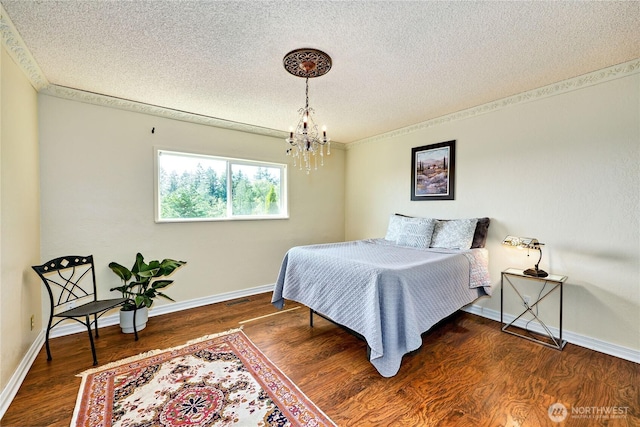 26421 Kingsview Loop NE, Kingston, WA 98346 - bedroom featuring a textured ceiling, a chandelier, wood finished floors, and baseboards