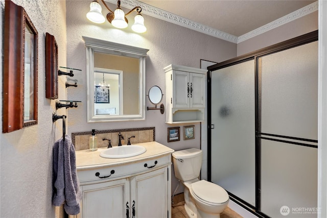 26421 Kingsview Loop NE, Kingston, WA 98346 - full bath featuring a textured wall, a stall shower, vanity, toilet, and ornamental molding