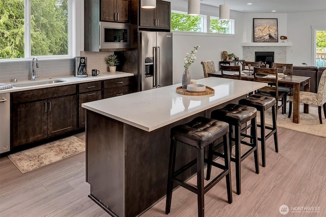 17012 106th Ave SE Lot 1, Renton, WA 98058 - kitchen featuring stainless steel appliances, a kitchen breakfast bar, light countertops, decorative backsplash, and recessed lighting