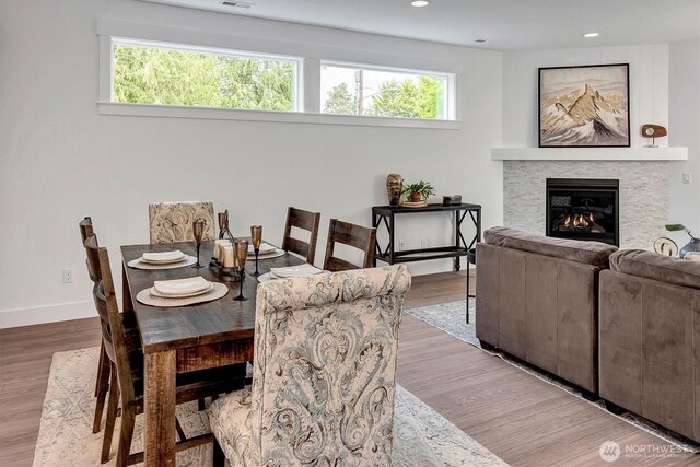 17012 106th Ave SE Lot 1, Renton, WA 98058 - dining area featuring plenty of natural light, a glass covered fireplace, wood finished floors, and recessed lighting