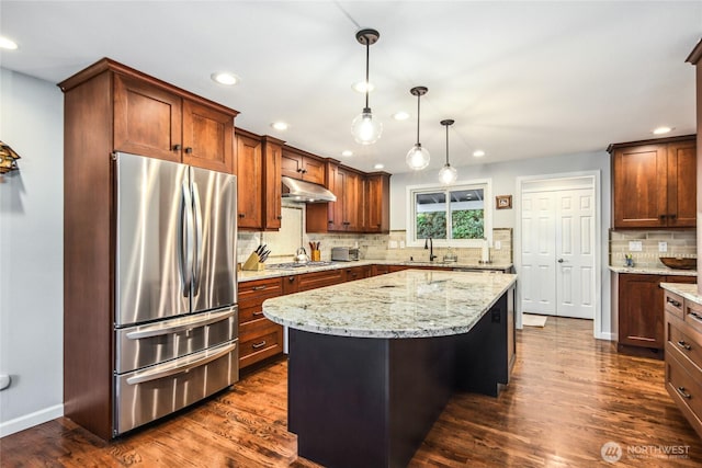 15068 NE 13th St, Bellevue, WA 98007 - kitchen with appliances with stainless steel finishes, under cabinet range hood, decorative backsplash, recessed lighting, and light stone counters