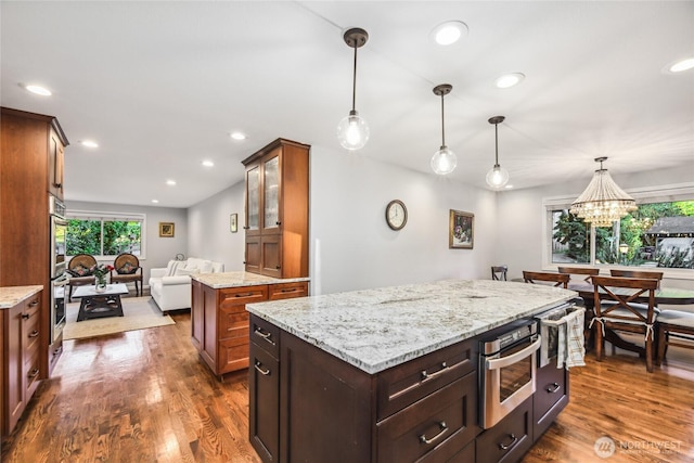 15068 NE 13th St, Bellevue, WA 98007 - kitchen with a center island, dark wood finished floors, light stone countertops, double oven, and recessed lighting