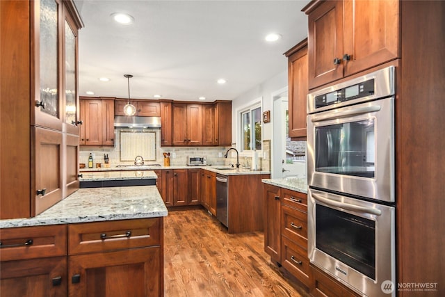 15068 NE 13th St, Bellevue, WA 98007 - kitchen featuring stainless steel appliances, under cabinet range hood, backsplash, dark wood finished floors, and light stone counters