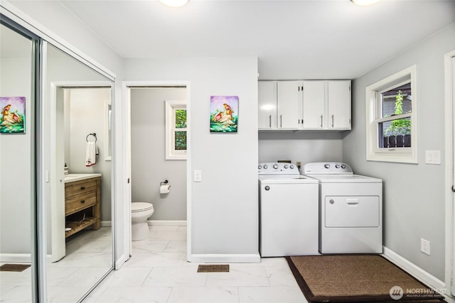 15068 NE 13th St, Bellevue, WA 98007 - washroom with independent washer and dryer, light marble finish flooring, and cabinet space