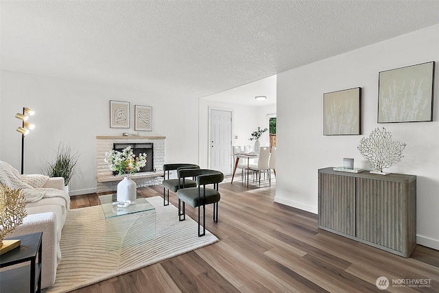 25035 34th Ave S, Kent, WA 98032 - living area with wood finished floors, a brick fireplace, and a textured ceiling