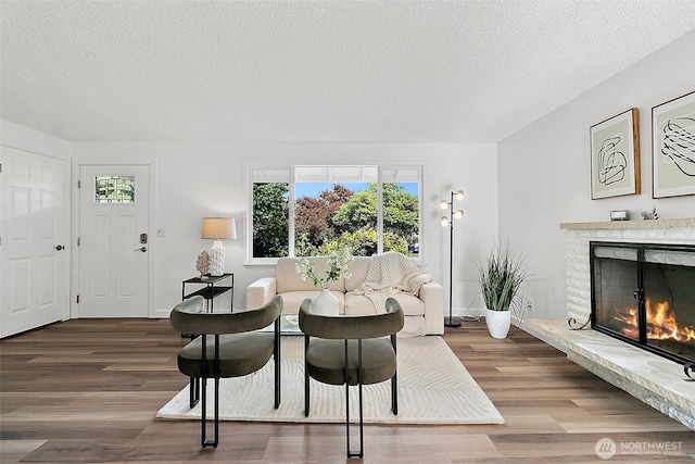 25035 34th Ave S, Kent, WA 98032 - living room with a textured ceiling, wood finished floors, and a fireplace