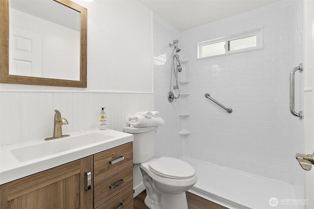 25035 34th Ave S, Kent, WA 98032 - bathroom featuring a wainscoted wall, vanity, a tile shower, and wood finished floors