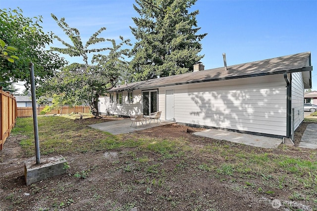 25035 34th Ave S, Kent, WA 98032 - back of house with a patio area and a chimney