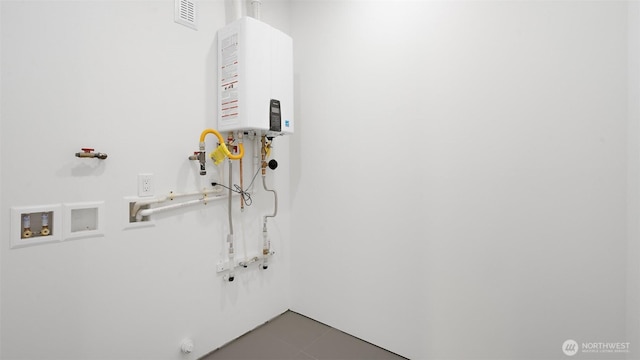 1114 26th Ave Unit B, Seattle, WA 98122 - washroom featuring water heater, washer hookup, and tile patterned flooring