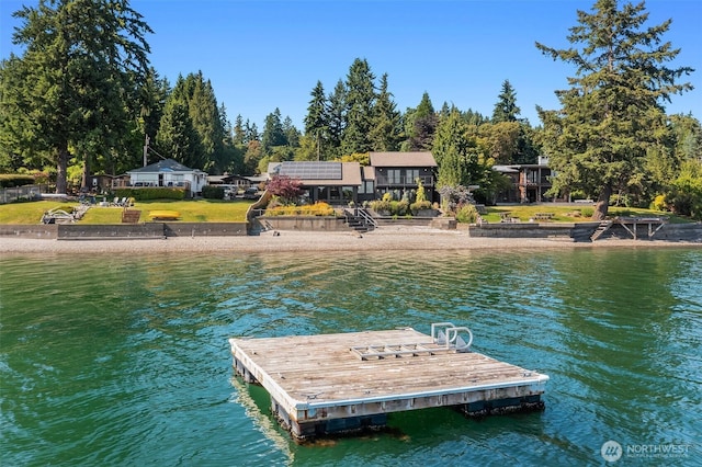 9707 SW Quartermaster Dr, Vashon, WA 98070 - dock area with a water view, a lawn, and view of scattered trees