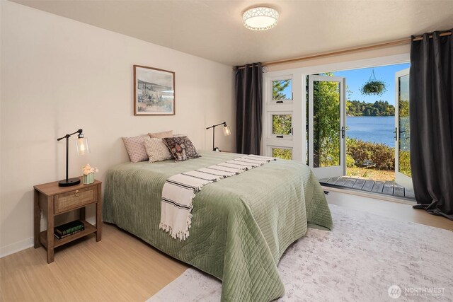 9707 SW Quartermaster Dr, Vashon, WA 98070 - bedroom with light wood-style floors and a water view