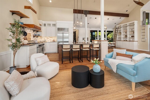 9707 SW Quartermaster Dr, Vashon, WA 98070 - living room featuring light wood-type flooring, beam ceiling, high vaulted ceiling, and recessed lighting