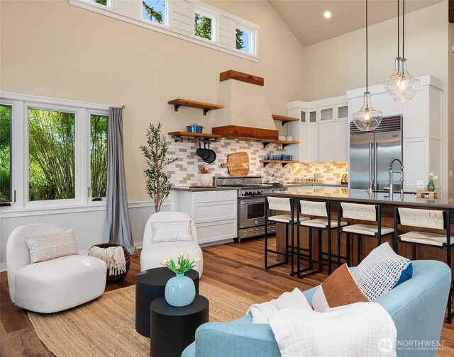 9707 SW Quartermaster Dr, Vashon, WA 98070 - living room featuring high vaulted ceiling, plenty of natural light, and wood finished floors