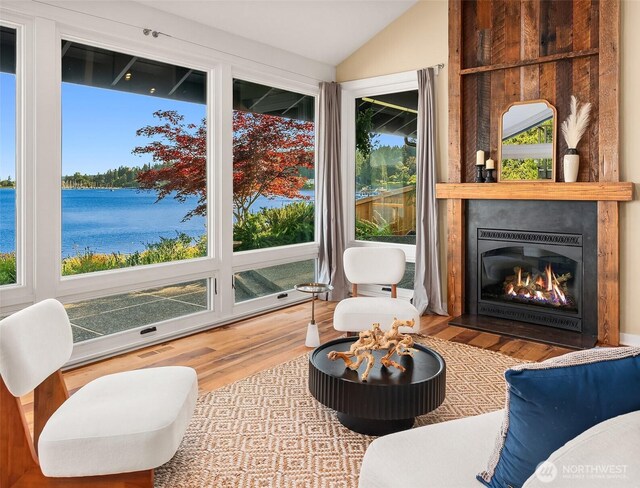 9707 SW Quartermaster Dr, Vashon, WA 98070 - sitting room with vaulted ceiling, wood finished floors, a water view, and a large fireplace