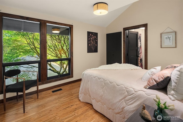 9707 SW Quartermaster Dr, Vashon, WA 98070 - bedroom featuring multiple windows, lofted ceiling, and light wood-style flooring