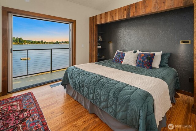 9707 SW Quartermaster Dr, Vashon, WA 98070 - bedroom with access to outside, wood finished floors, and vaulted ceiling