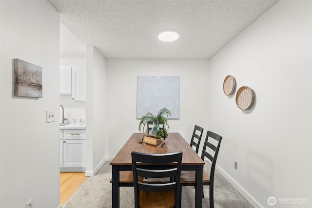 1506 N Defiance St Unit R205, Tacoma, WA 98406 - dining area with a textured ceiling and baseboards
