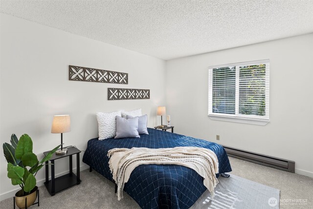 1506 N Defiance St Unit R205, Tacoma, WA 98406 - bedroom with a baseboard heating unit, carpet floors, and a textured ceiling