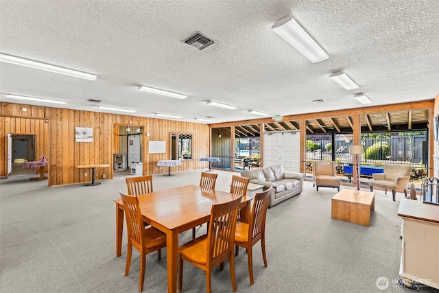 1506 N Defiance St Unit R205, Tacoma, WA 98406 - dining area with a textured ceiling, wooden walls, and carpet