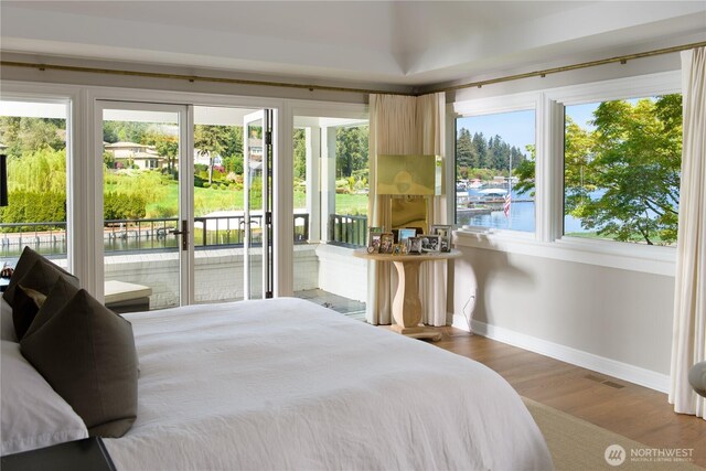 8580 Hunts Point Ln, Hunts Point, WA 98004 - bedroom with baseboards, access to exterior, multiple windows, and wood finished floors