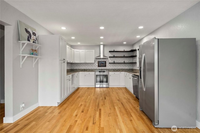 113 W Chenault Ave, Hoquiam, WA 98550 - kitchen featuring open shelves, appliances with stainless steel finishes, wall chimney range hood, dark countertops, and light wood-style floors