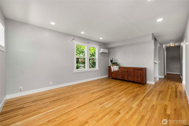 113 W Chenault Ave, Hoquiam, WA 98550 - unfurnished living room featuring a wall unit AC, light wood finished floors, baseboards, and recessed lighting