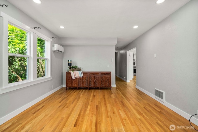 113 W Chenault Ave, Hoquiam, WA 98550 - unfurnished living room featuring a wall mounted air conditioner, recessed lighting, light wood-style floors, and baseboards