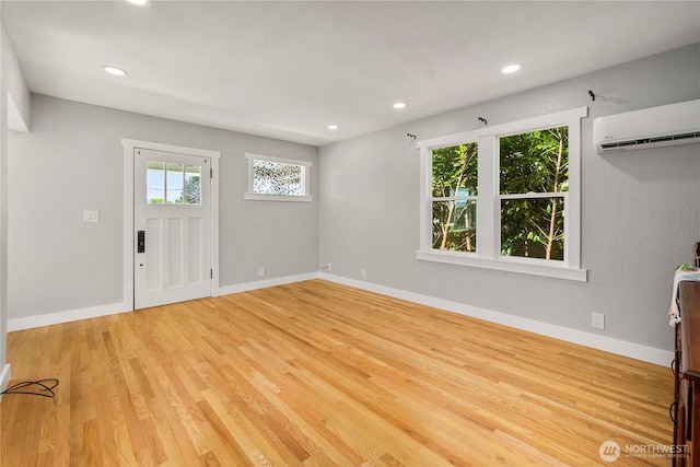 113 W Chenault Ave, Hoquiam, WA 98550 - unfurnished living room featuring wood finished floors, a wall mounted air conditioner, recessed lighting, and baseboards