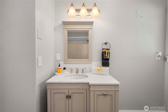 113 W Chenault Ave, Hoquiam, WA 98550 - bathroom with vanity, decorative backsplash, and a textured wall