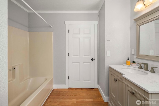 113 W Chenault Ave, Hoquiam, WA 98550 - bathroom featuring wood finished floors, vanity, ornamental molding, shower / bath combination, and baseboards