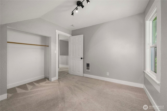 113 W Chenault Ave, Hoquiam, WA 98550 - unfurnished bedroom featuring carpet flooring, heating unit, a closet, lofted ceiling, and baseboards