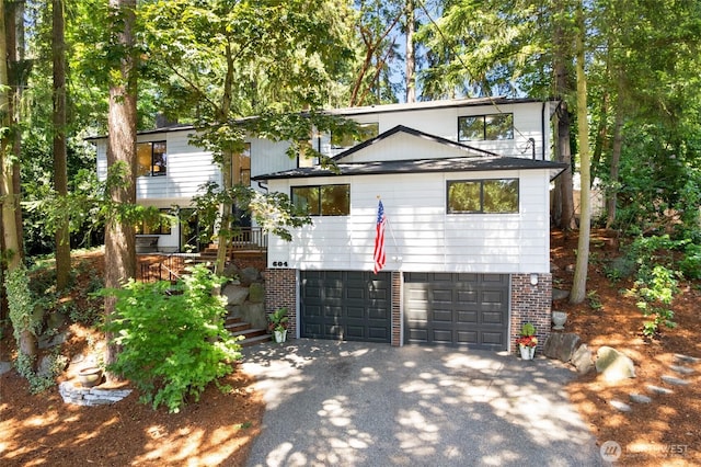 604 N 178th St, Shoreline, WA 98133 - view of front of house featuring asphalt driveway, a garage, stairs, and brick siding