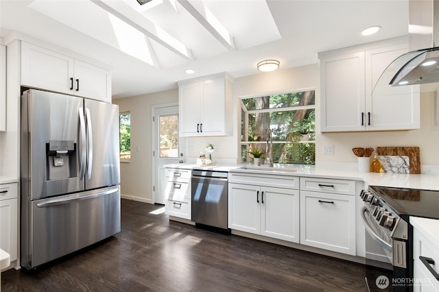 604 N 178th St, Shoreline, WA 98133 - kitchen with stainless steel appliances, a sink, wall chimney exhaust hood, dark wood-style flooring, and light countertops