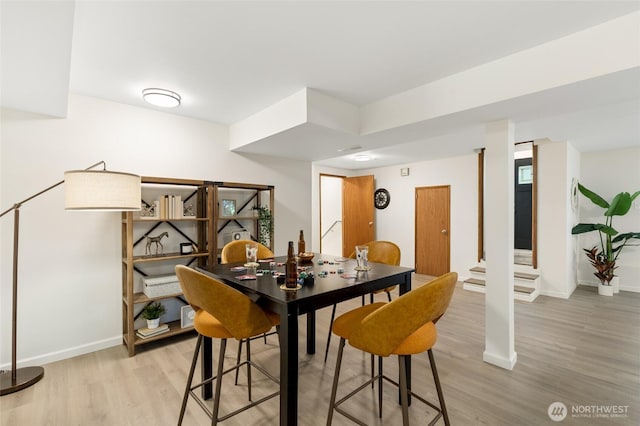 604 N 178th St, Shoreline, WA 98133 - dining area with light wood finished floors, baseboards, and stairway