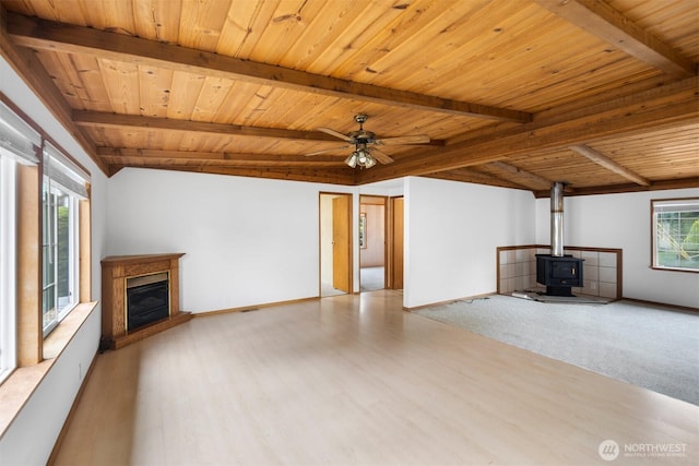 14803 SE 306th St, Kent, WA 98042 - unfurnished living room featuring a wood stove, wooden ceiling, wood finished floors, a ceiling fan, and baseboards