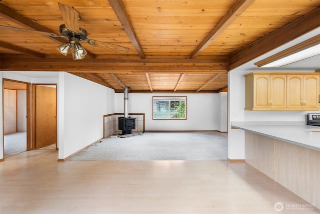 14803 SE 306th St, Kent, WA 98042 - unfurnished living room featuring a wood stove, wood ceiling, light wood-style flooring, light carpet, and a ceiling fan