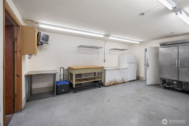 14803 SE 306th St, Kent, WA 98042 - garage with freestanding refrigerator and a workshop area
