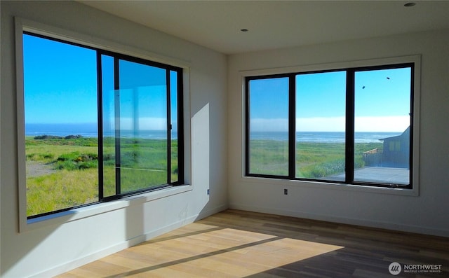 1421 S Cohasset Crst, Westport, WA 98595 - spare room with wood finished floors, baseboards, and a water view