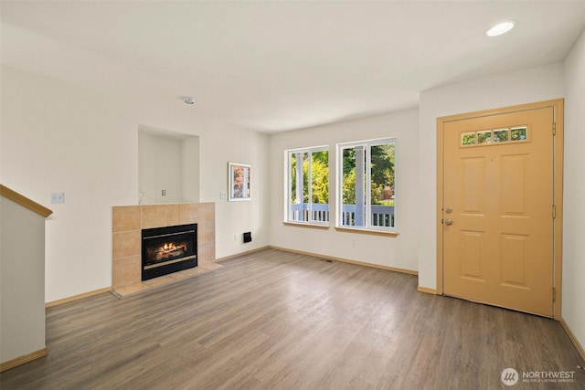 10040 19th Ave SW, Seattle, WA 98146 - unfurnished living room with wood finished floors, baseboards, a fireplace, and recessed lighting