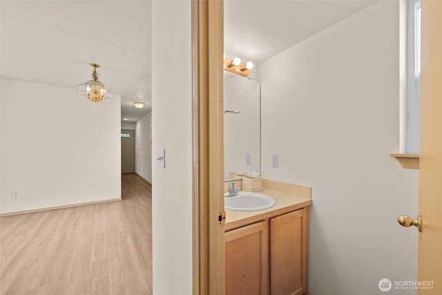 10040 19th Ave SW, Seattle, WA 98146 - bathroom with vanity, wood finished floors, and a chandelier