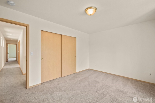 10040 19th Ave SW, Seattle, WA 98146 - unfurnished bedroom featuring light colored carpet, a closet, and baseboards