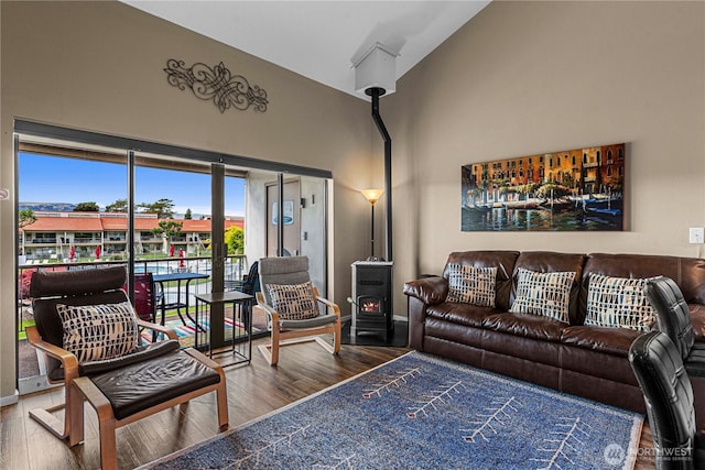8903 Crescent Bar Rd NW Unit 18, Quincy, WA 98848 - living room featuring wood finished floors, baseboards, a wood stove, and a towering ceiling