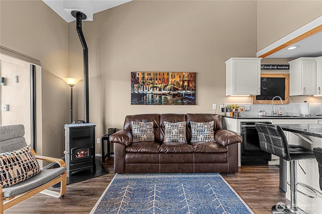 8903 Crescent Bar Rd NW Unit 18, Quincy, WA 98848 - living area featuring a wood stove, dark wood-type flooring, a high ceiling, and recessed lighting