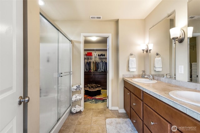 5418 Bennett Ave SE, Auburn, WA 98092 - full bathroom featuring a spacious closet, double vanity, a shower stall, and tile patterned flooring