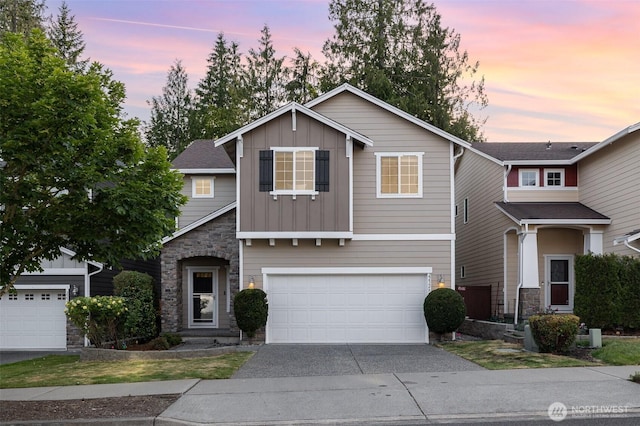 22326 35th Dr SE, Bothell, WA 98021 - traditional-style house with board and batten siding, asphalt driveway, a garage, and stone siding