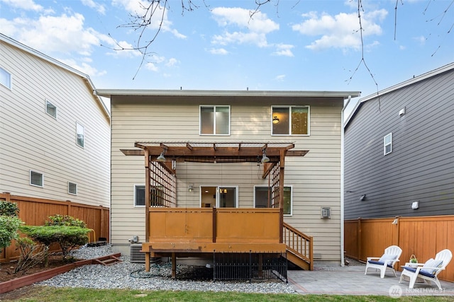 22326 35th Dr SE, Bothell, WA 98021 - rear view of house featuring a wooden deck, a pergola, a fenced backyard, a patio, and central AC unit