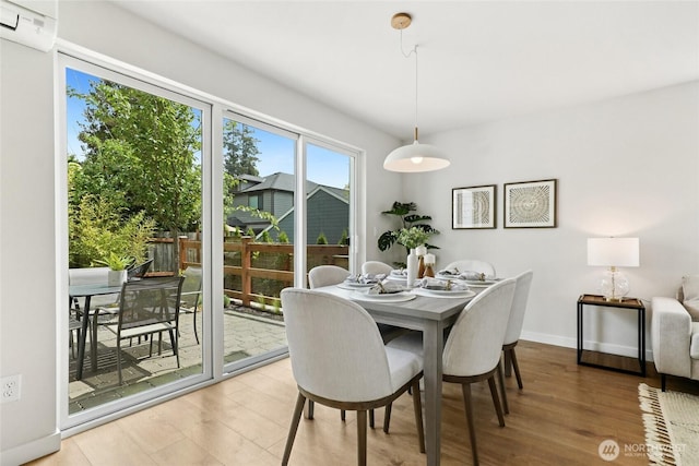 6014 40th Ave NE Unit B, Seattle, WA 98115 - dining space with light wood-type flooring, a wall unit AC, and baseboards