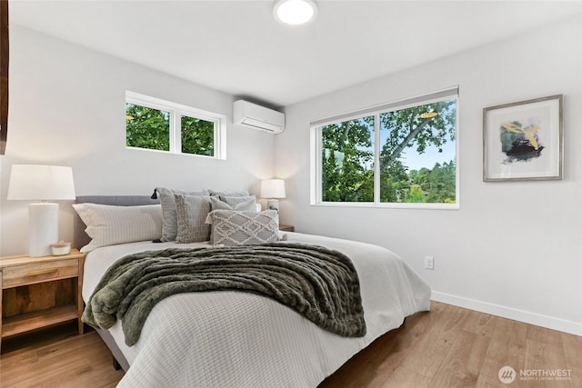 6014 40th Ave NE Unit B, Seattle, WA 98115 - bedroom with a wall mounted AC, baseboards, and light wood-style flooring