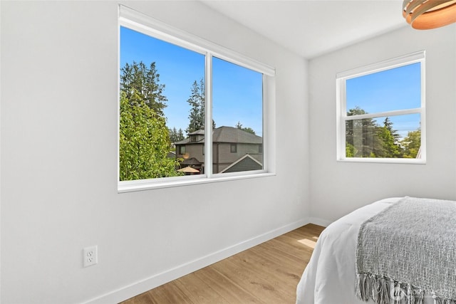 6014 40th Ave NE Unit B, Seattle, WA 98115 - bedroom featuring baseboards and wood finished floors