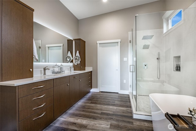 8054 Makah Rd, Birch Bay, WA 98230 - full bathroom with vanity, a freestanding tub, a shower stall, and wood finished floors